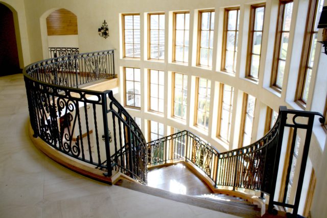 interior curved grand stairs and balcony railings 
